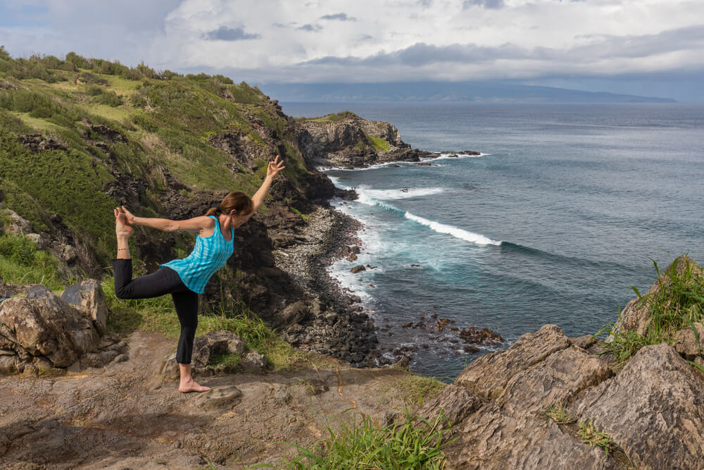 Photo of a person doing yoga during a Maui wellness retreat