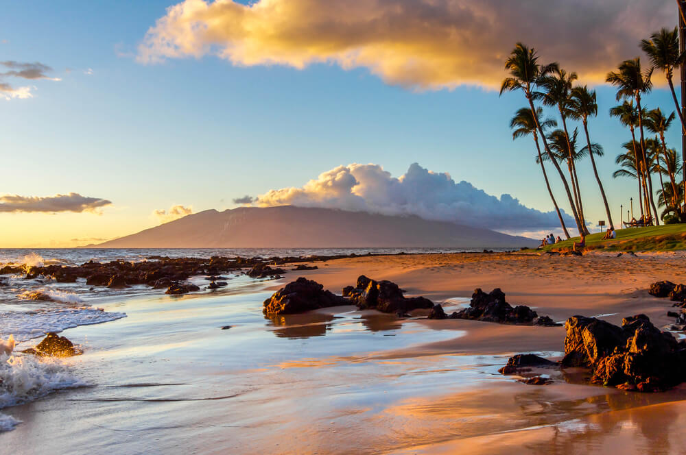 Picture of Maui beach at sunset featured in a blog covering how to help Maui after wildfires